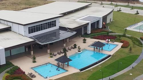 an overhead view of a building with two swimming pools at Tagaytay Nordic Nest Staycation at Wind Residences with Netflix Wifi near Sky Ranch in Tagaytay