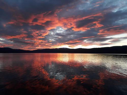 a sunset over a large body of water at Villa Uuttu in Kuusamo