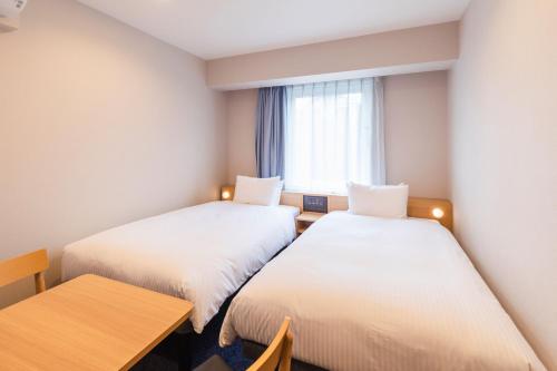 Ένα ή περισσότερα κρεβάτια σε δωμάτιο στο Sotetsu Fresa Inn Yodoyabashi