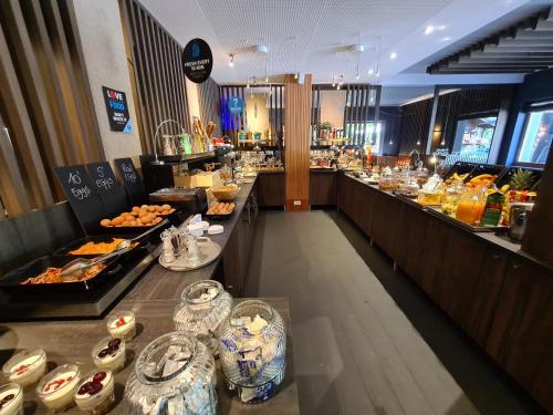a buffet line in a restaurant with food on display at Smart Hotel Saslong in Santa Cristina in Val Gardena