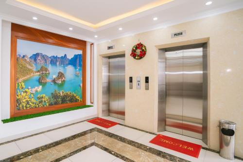 an elevator lobby with a large painting on the wall at Thành An Hotel in Ha Long