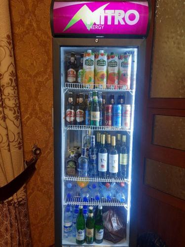 a refrigerator filled with lots of bottles of soda at Зона отдых APACHI в горах ЧИМГАН in Chimgan