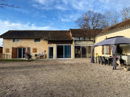 une maison avec un parapluie devant dans l'établissement Au bonheur des animaux, à Auriébat