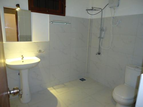 a bathroom with a sink and a toilet at Yala wind in Tissamaharama