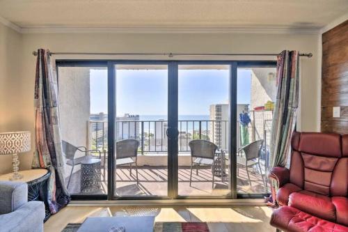 a living room with a view of a balcony at Coastal Escape Penthouse with Ocean Views in Myrtle Beach
