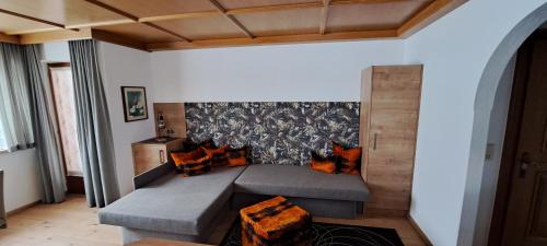 a living room with a gray couch in a room at Apartment Martina in Ramsau im Zillertal