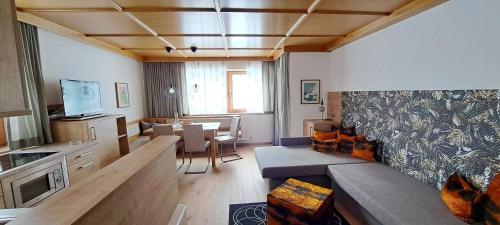 a living room with a couch and a dining room at Apartment Martina in Ramsau im Zillertal