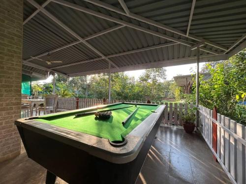 a pool table sitting on top of a patio at Stay Leisurely Organic Brew Pool 2BHK, Karjat in Karjat