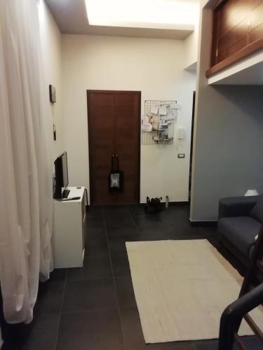 a living room with a couch and a door at Terrazza Roberto in Cefalù