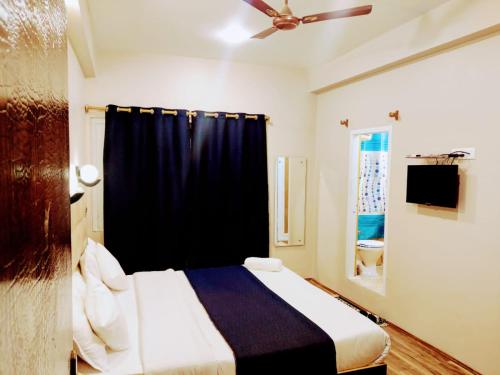 a bedroom with a bed with a black curtain at Gulshan Palace By Seven Hills Srinagar By Him Haults Hospitality in Srinagar