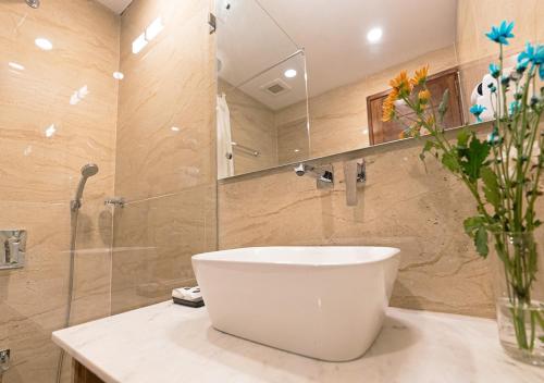 a bathroom with a white sink and a mirror at The Verda De Miranda Resort Morjim North Goa in Morjim