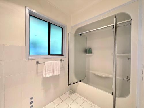 een badkamer met een douche en een raam bij Blue Lily Bungalow in Katoomba