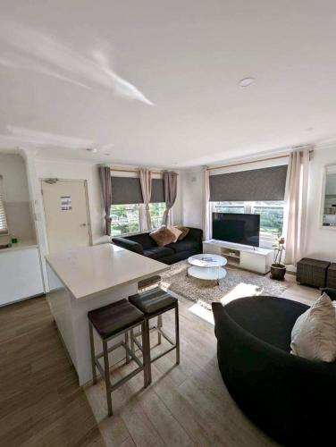 a living room with a couch and a table at Lotus Stay Manly - Apartment 31E in Sydney