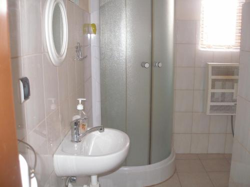 a bathroom with a sink and a shower at Chalupa Iveta in Oščadnica