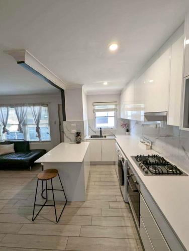 a kitchen with white counters and a stove top oven at Lotus Stay Manly - Apartment 31H in Sydney