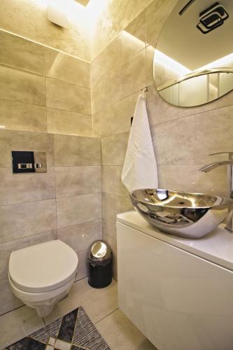 a bathroom with a toilet and a sink at Motel Na Zbójeckiej in Skawa