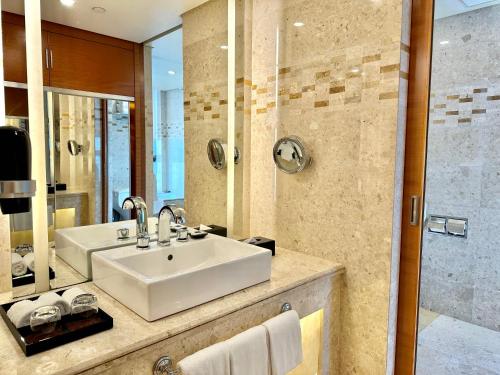 a bathroom with a sink and a shower at Swissotel Foshan, Guangdong - Free shuttle to Canton Fair in Foshan