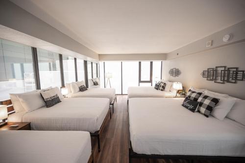 a room with three beds and a couch at Right on The Strip - 3BR Condo 1110 in Las Vegas