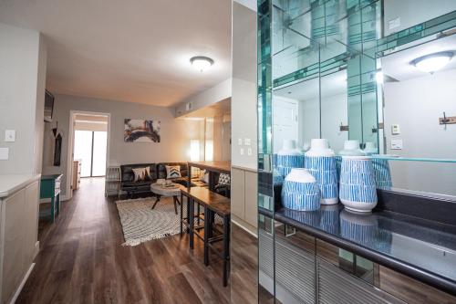 a living room with vases on a glass case at Right on The Strip - 3BR Condo 1110 in Las Vegas