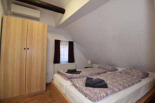 a bedroom with two beds and a wooden cabinet at PM CityAPART Lend in Graz