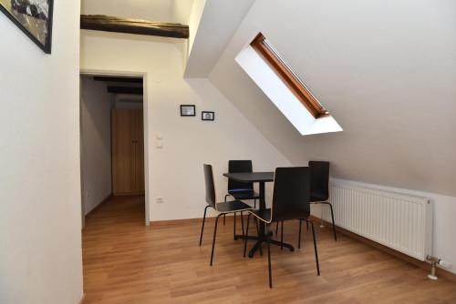 a dining room with a table and chairs in a attic at PM CityAPART Lend in Graz
