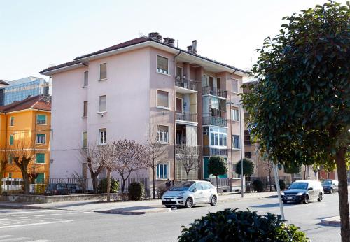 um prédio de apartamentos com carros estacionados em frente em B&B Il Rosso e il Blu em Cuneo