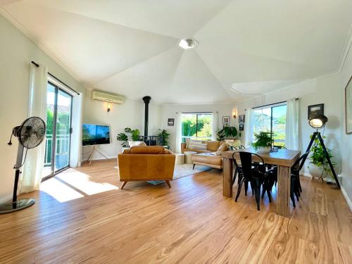 a living room with a table and a couch at Blue Lily Bungalow in Katoomba
