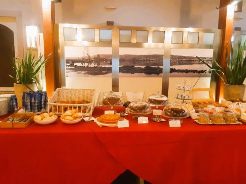 a red table with food on top of it at Hotel Moderno in SantʼAntìoco