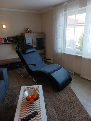 a living room with a bean bag chair and a table at bei den Geißens in Aldersbach