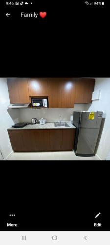 a small kitchen with a sink and a refrigerator at VICTORIA DE MAKATI Two (2) Bedroom Up and Down Condo in Manila