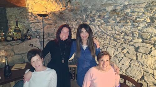a group of women posing for a picture in front of a stone wall at Bed & Breakfast Casa Marinella in Lenna