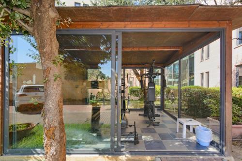 una entrada de cristal a un edificio con un árbol en L'incanto Di Boccadarno, en Marina di Pisa