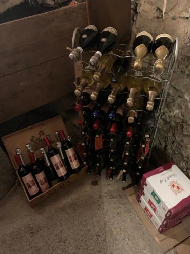 a bunch of wine bottles on a rack at Bed & Breakfast Casa Marinella in Lenna