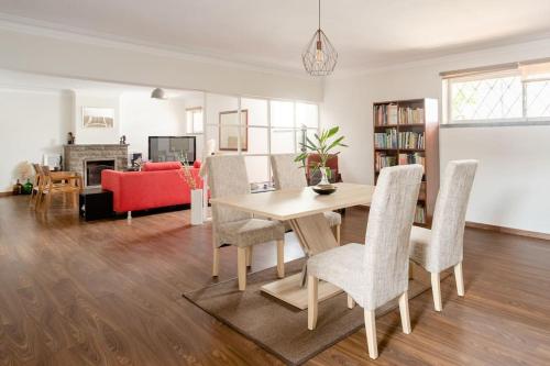 a living room with a wooden table and chairs at Vinaika Loft in Oeiras