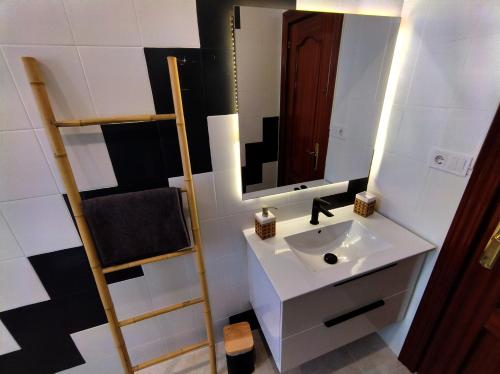 a bathroom with a sink and a mirror at ROOMS in SHARED APARTMENT with HOST in Alicante