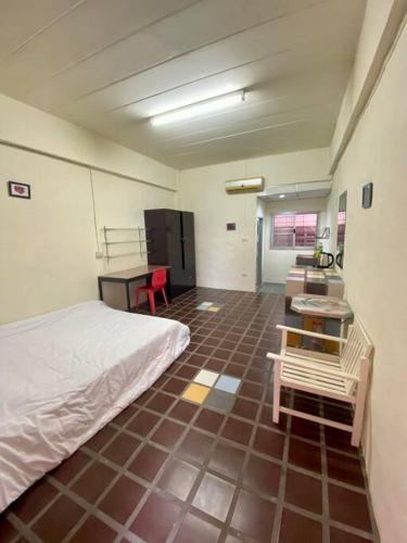 a bedroom with a bed and a table and a desk at Ratanawong Place 507 in Bangkok