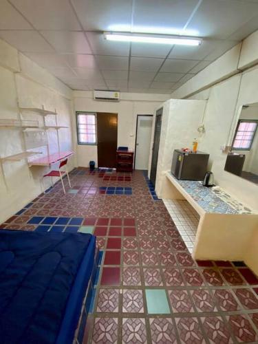 a room with a room with colorful tiles on the floor at Ratanawong Place 406 in Bangkok
