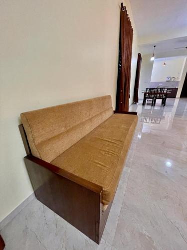 a wooden bench sitting in a room with a room with tables at Aikya Kadri #Your Home Away from Home# non Smoke# Vegetarians Preferred# Strictly for Families in Mangalore