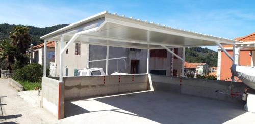 a garage with a roof over a parking lot at Sunset Vela Luka in Vela Luka
