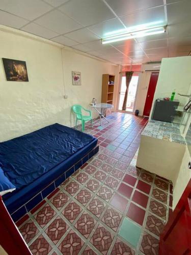 a room with a bed and a tiled floor at Ratanawong Place 404 in Bangkok
