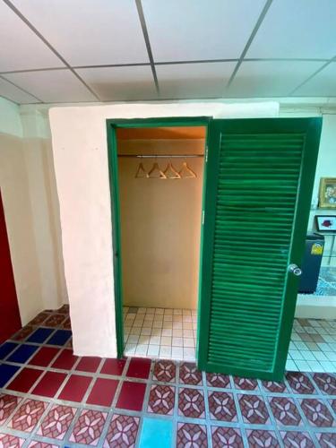 an open door to a closet with hangers at Ratanawong Place 404 in Bangkok