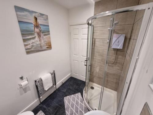 a bathroom with a shower stall and a toilet at nc23, setup for your most amazing & relaxed stay + Free Parking + Free Fast WiFi in Farnley