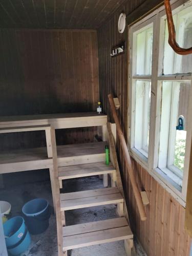 a room with stairs in a house with a window at Hideaway for holiday season, hot tube, two saunas in Hämeenlinna
