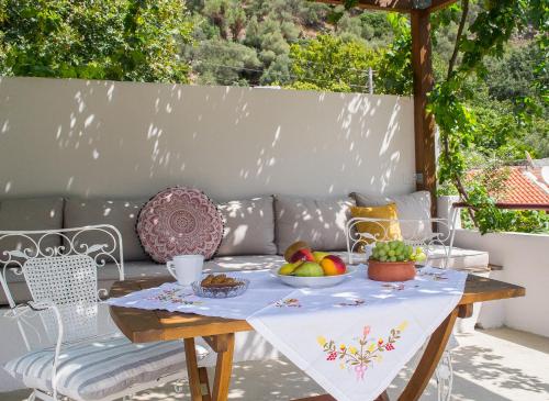 a table with fruit on it on a patio at Feneri 3 -Cozy rustic Apt 20' from Elafonisi beach in Elafonisi
