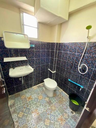 a bathroom with a toilet and a sink and a shower at Ratanawong Place 823 in Bangkok