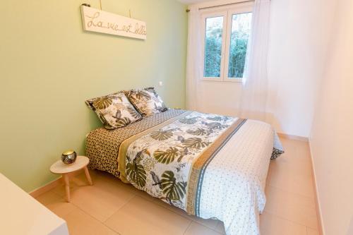 a bedroom with a bed and a window at Cozy Nest By the Zoo in Mulhouse