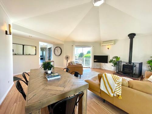 a living room with a table and a couch at Blue Lily Bungalow in Katoomba