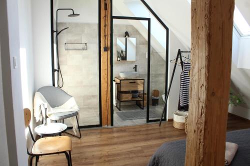 a bathroom with a mirror and a chair and a sink at Kafe v obýváku in Bítov