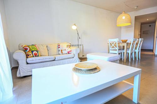 a living room with a couch and a table at Ciutadella Litoral - ONLY FAMILIES in Cambrils
