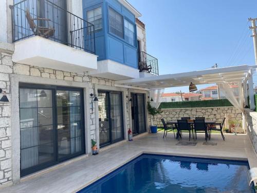 a house with a swimming pool and a patio at Detached villa in Alaçatı… in Alacati